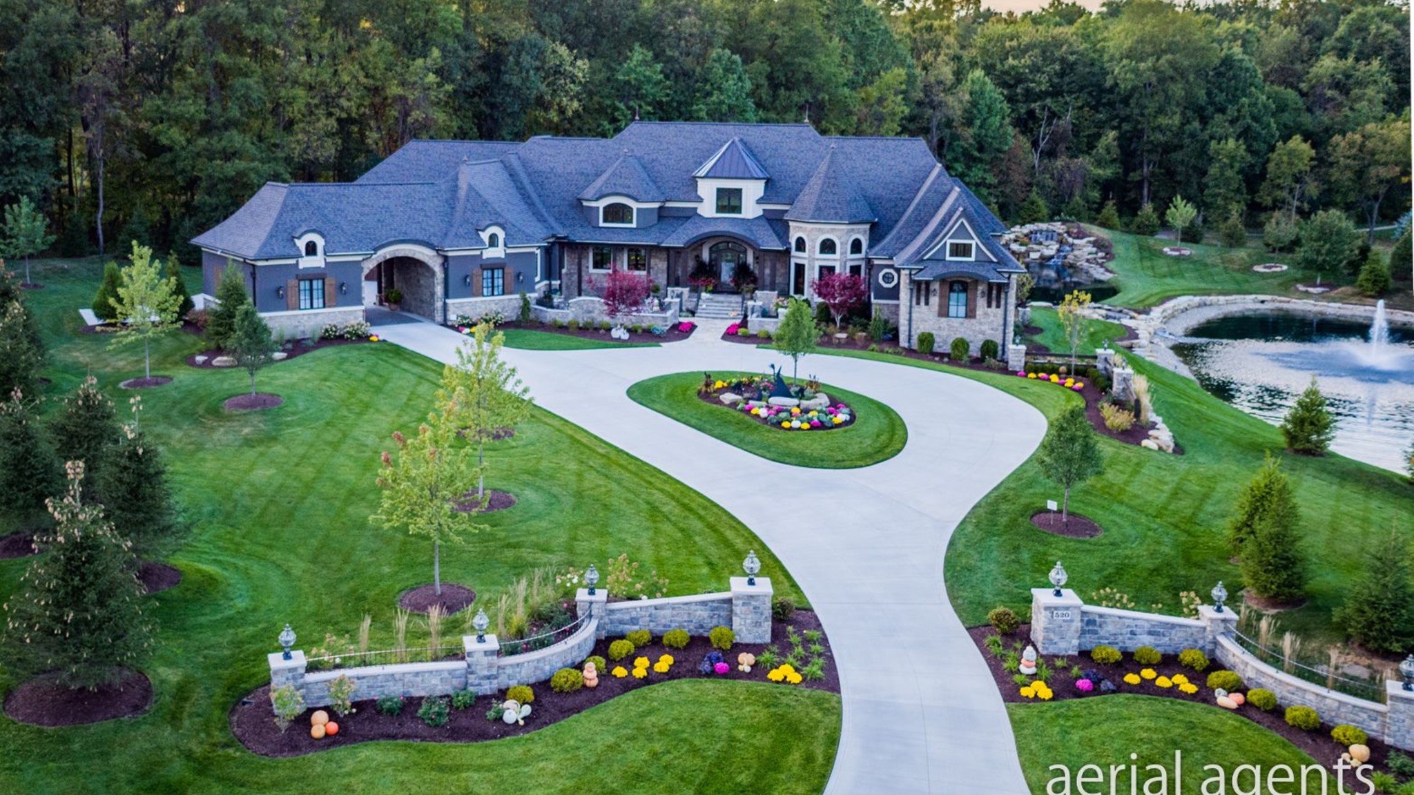 Aerial view of a custom home and landscaped grounds